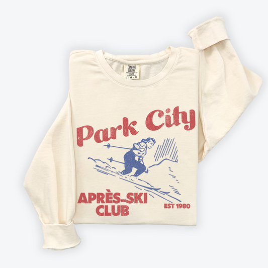 Park City Après Ski Club Comfort Colors lightweight crewneck sweatshirt featuring a female skier design with vintage retro grunge vibes, ideal for ski trips and winter getaways.