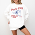 Park City Après Ski Club Comfort Colors lightweight crewneck sweatshirt featuring a female skier design with vintage retro grunge vibes, ideal for ski trips and winter getaways.