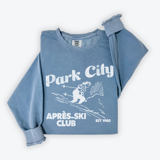 Park City Après Ski Club Comfort Colors lightweight crewneck sweatshirt featuring a female skier design with vintage retro grunge vibes, ideal for ski trips and winter getaways.