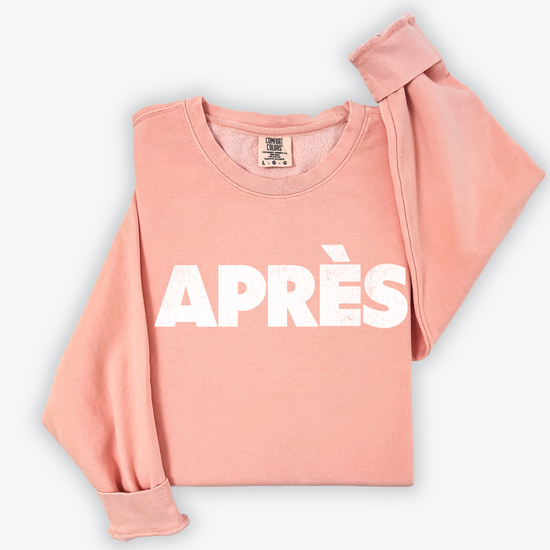 Comfort Colors lightweight crewneck sweatshirt with "Après" in bold print and a faded vintage grunge look, ideal for casual winter and après-ski occasions.