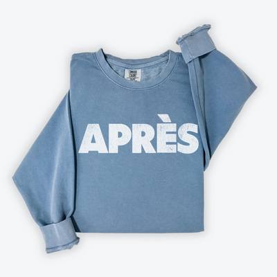 Comfort Colors lightweight crewneck sweatshirt with "Après" in bold print and a faded vintage grunge look, ideal for casual winter and après-ski occasions.