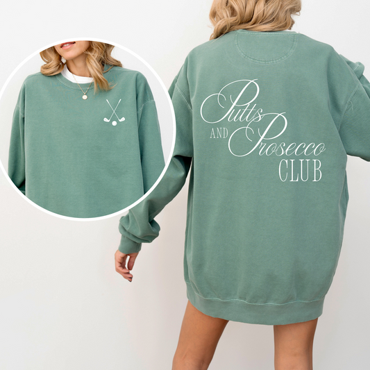 Unisex Comfort Colors sweatshirt with “Puts and Prosecco Club” in vintage style print on the back and crossed golf clubs on the front pocket