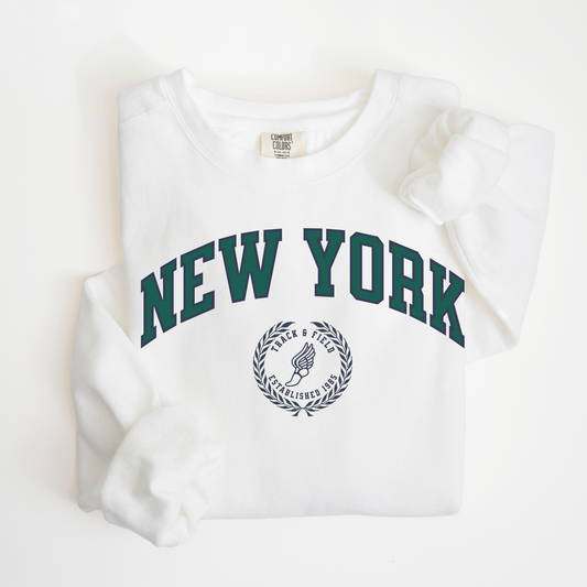 A Comfort Colors lightweight cotton crewneck sweatshirt with "New York Track & Field" printed in vintage retro style, giving a refined old money look.