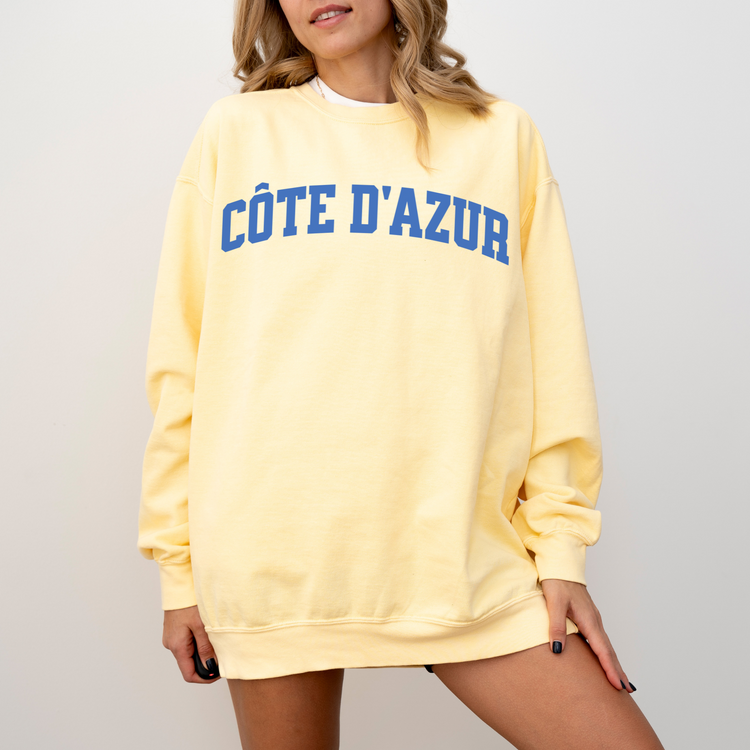 Côte d'Azur Comfort Colors lightweight cotton crewneck sweatshirt in a simple, sporty university font, perfect for travel days with a relaxed and comfortable fit.